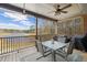Relaxing covered patio with ceiling fan overlooking a serene lake view and outdoor seating at 5168 Parkview Rd, Social Circle, GA 30025