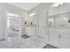 Bright bathroom with marble floors, double sinks, and an open doorway at 812 Newsome Nw Aly, Marietta, GA 30064