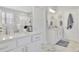 White bathroom featuring double sinks, a shower, and a window at 812 Newsome Nw Aly, Marietta, GA 30064