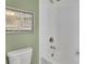 Bright bathroom with white subway tile, toilet, and vintage wall art at 812 Newsome Nw Aly, Marietta, GA 30064