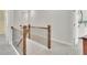 Upstairs hallway with wood and iron railing, neutral walls, grey carpet, and bright natural light at 812 Newsome Nw Aly, Marietta, GA 30064
