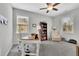 Well-lit office space with two windows, neutral walls, ceiling fan, desk, office chair and a book shelf at 812 Newsome Nw Aly, Marietta, GA 30064