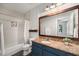 Bathroom features a tiled shower over tub, single sink and a decorative wood-framed mirror at 821 Ralph Mcgill Ne Blvd # 2210, Atlanta, GA 30306