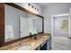 Bathroom featuring double sinks, granite countertops, wood-framed mirror, and views to the adjacent room at 821 Ralph Mcgill Ne Blvd # 2210, Atlanta, GA 30306
