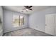 Carpeted bedroom with a ceiling fan, large window, and access door at 821 Ralph Mcgill Ne Blvd # 2210, Atlanta, GA 30306