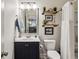 Well-lit bathroom with a vanity, toilet, shower, and decorative shelves at 187 Still Pine Bnd, Smyrna, GA 30082