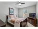 Comfortable bedroom with ceiling fan, large window, and neutral decor at 187 Still Pine Bnd, Smyrna, GA 30082