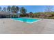 Large community pool with clear blue water, surrounded by a concrete deck and landscaping at 187 Still Pine Bnd, Smyrna, GA 30082
