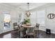 Charming dining area with round table, hardwood floors, and natural light from large window at 187 Still Pine Bnd, Smyrna, GA 30082