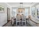 Formal dining room with modern lighting, wainscoting, and ample natural light at 187 Still Pine Bnd, Smyrna, GA 30082