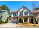 Charming two-story home with stone accents, a two-car garage, and a well-manicured lawn at 187 Still Pine Bnd, Smyrna, GA 30082