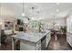 Open-concept kitchen with a large island, granite countertops, and stainless steel appliances at 187 Still Pine Bnd, Smyrna, GA 30082