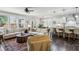 Open-concept living room with hardwood floors, ceiling fan, and lots of natural light from large windows at 187 Still Pine Bnd, Smyrna, GA 30082