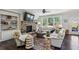 Cozy living room featuring a stone fireplace, built-in shelving, and a large window at 187 Still Pine Bnd, Smyrna, GA 30082