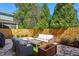 Landscaped backyard patio featuring stone pavers, an outdoor grill, and comfortable seating at 187 Still Pine Bnd, Smyrna, GA 30082