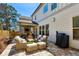 Inviting outdoor patio with stone pavers, an outdoor fireplace, and comfortable seating at 187 Still Pine Bnd, Smyrna, GA 30082