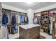 Spacious walk-in closet with custom shelving and center island with marble countertop at 187 Still Pine Bnd, Smyrna, GA 30082