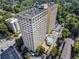Aerial view of a high rise apartment building featuring a pool, parking and landscaping at 2479 Peachtree Ne Rd # 1606, Atlanta, GA 30305