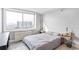 This naturally lit bedroom has carpet, neutral walls, a side table, and a large window view at 2479 Peachtree Ne Rd # 1606, Atlanta, GA 30305