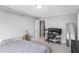 This bedroom features neutral walls, carpet and trim, and also contains a computer desk, shelving and decor at 2479 Peachtree Ne Rd # 1606, Atlanta, GA 30305