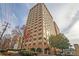 Exterior view of the high-rise building featuring landscaping and parking at 2479 Peachtree Ne Rd # 1606, Atlanta, GA 30305