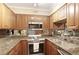 Galley kitchen featuring granite countertops and stainless steel appliances at 2479 Peachtree Ne Rd # 1606, Atlanta, GA 30305