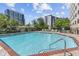 Community swimming pool surrounded by lounge chairs and landscaping at 2479 Peachtree Ne Rd # 1606, Atlanta, GA 30305