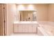 Bright bathroom featuring double sink vanity, large mirror, and soaking tub at 50 Biscayne Nw Dr # 6111, Atlanta, GA 30309