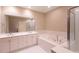 Luxurious bathroom with double sinks, jacuzzi tub, and glass enclosed shower at 50 Biscayne Nw Dr # 6111, Atlanta, GA 30309
