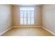 Sunlit bedroom featuring neutral walls, carpet, and large window with blinds at 50 Biscayne Nw Dr # 6111, Atlanta, GA 30309