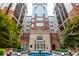 Elegant brick condominium building featuring a central water fountain and manicured landscaping at 50 Biscayne Nw Dr # 6111, Atlanta, GA 30309