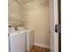 Bright laundry room featuring washer and dryer, with ample shelving for storage at 50 Biscayne Nw Dr # 6111, Atlanta, GA 30309