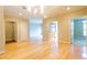 Open-concept living room with hardwood floors, neutral walls, and access to kitchen and bedrooms at 50 Biscayne Nw Dr # 6111, Atlanta, GA 30309