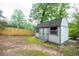 Backyard shed with neutral colors and double door entry sits in a spacious yard with a privacy fence in the background at 5384 Blackhawk Dr, Acworth, GA 30102