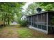 Enclosed back porch with screened in walls and small backyard shed at 5384 Blackhawk Dr, Acworth, GA 30102