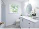 Modern bathroom featuring stylish vanity, marble countertops, and a bright oval mirror at 5384 Blackhawk Dr, Acworth, GA 30102