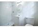 Bright bathroom showcasing a tiled walk-in shower, modern vanity and a round decorative mirror at 5384 Blackhawk Dr, Acworth, GA 30102