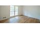Bright bedroom with vinyl floors, white walls, and French doors leading to the outside at 5384 Blackhawk Dr, Acworth, GA 30102