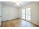 This bright bedroom features wood-look floors and a private door to the backyard at 5384 Blackhawk Dr, Acworth, GA 30102