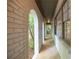Long view of brick arched entry with white painted brick and window on right side at 5384 Blackhawk Dr, Acworth, GA 30102