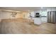 Open kitchen and living area with stainless steel appliances, island, and wood floors at 5384 Blackhawk Dr, Acworth, GA 30102