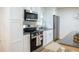 Bright kitchen featuring stainless steel appliances, white cabinets, and a granite countertop island at 5384 Blackhawk Dr, Acworth, GA 30102