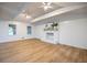 Spacious living room features a brick fireplace, wood floors, lots of natural light, and ceiling fans at 5384 Blackhawk Dr, Acworth, GA 30102