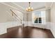 Bright dining room featuring hardwood floors, wainscoting, and chandelier at 1047 Panoramic Pointe, Buford, GA 30518