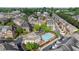 Aerial view of a neighborhood with a swimming pool, townhomes, and mature trees at 2130 Monhegan Se Way # 11, Smyrna, GA 30080