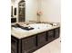 Close up of a jacuzzi tub with granite surround, dark cabinets, and picture window at 2130 Monhegan Se Way # 11, Smyrna, GA 30080