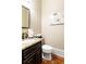 Powder room featuring a granite countertop, dark cabinets, and wood flooring at 2130 Monhegan Se Way # 11, Smyrna, GA 30080