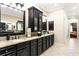 Bathroom with granite countertops, dual sinks, dark cabinetry, large mirrors, and tile floors at 2130 Monhegan Se Way # 11, Smyrna, GA 30080