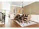 Bright dining room boasts wood floors, wainscoting, stylish light fixture, and seating for six at 2130 Monhegan Se Way # 11, Smyrna, GA 30080