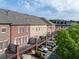 Exterior view of brick townhomes featuring private balconies and rear parking in a friendly neighborhood at 2130 Monhegan Se Way # 11, Smyrna, GA 30080